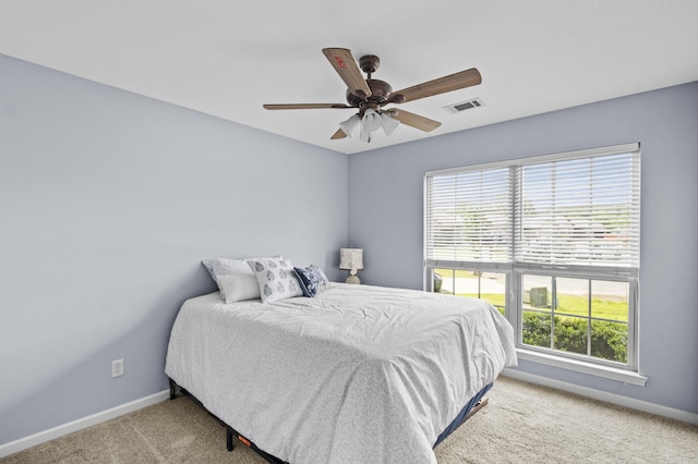 carpeted bedroom featuring baseboards and a ceiling fan