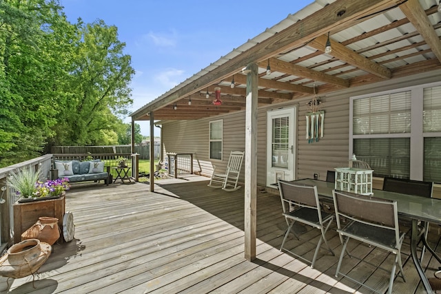 deck featuring fence, outdoor dining area, and outdoor lounge area