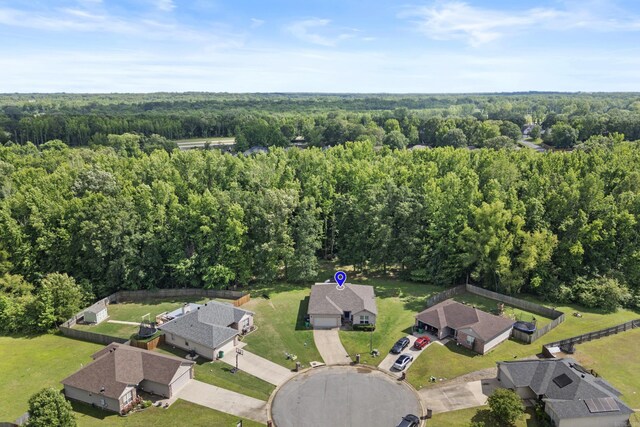 aerial view of property's location with a heavily wooded area