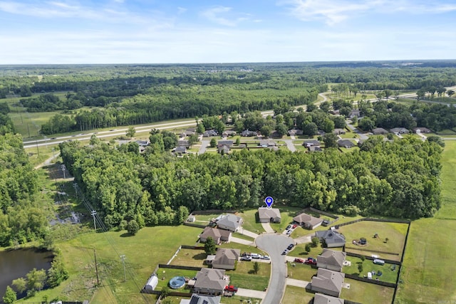 view of property location with a heavily wooded area