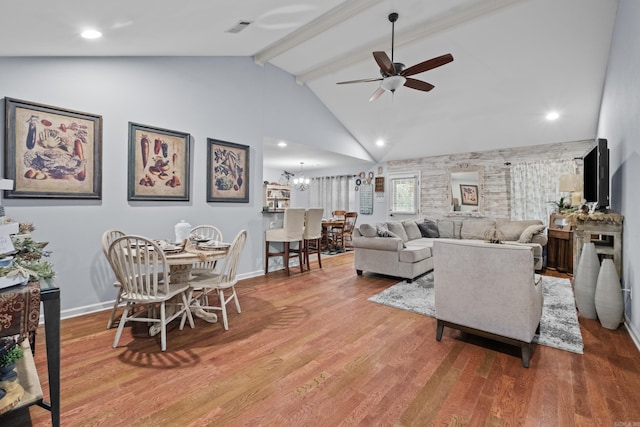 living area with a ceiling fan, wood finished floors, beam ceiling, baseboards, and high vaulted ceiling