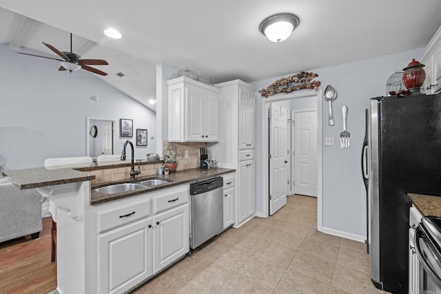 kitchen with stainless steel appliances, a sink, a ceiling fan, white cabinetry, and a peninsula