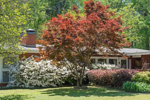 107 W Sunset, Sheridan, AR 72150 - rear view of property with a chimney and a lawn