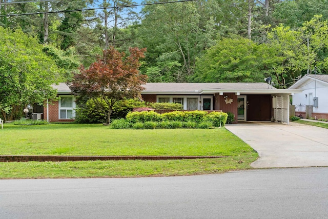 107 W Sunset, Sheridan, AR 72150 - view of front of property featuring concrete driveway, a front yard, a carport, and central AC unit