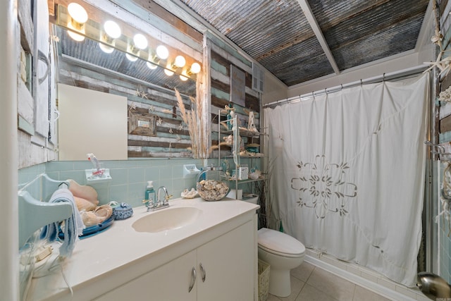 107 W Sunset, Sheridan, AR 72150 - full bathroom with tile patterned flooring, toilet, a shower with shower curtain, vanity, and tile walls