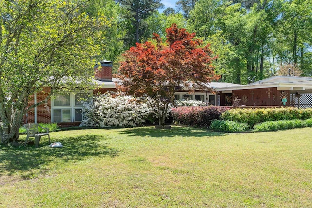 107 W Sunset, Sheridan, AR 72150 - view of front of house with a front lawn and a chimney