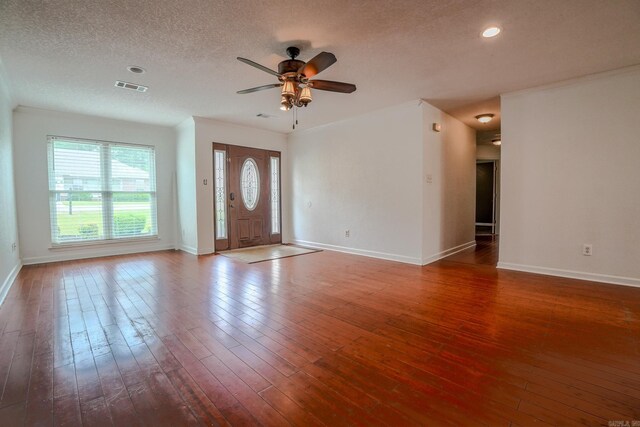 unfurnished living room with ceiling fan, baseboards, hardwood / wood-style floors, a textured ceiling, and recessed lighting