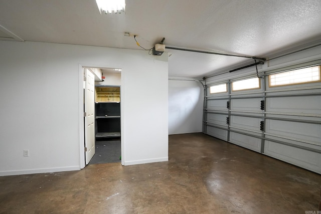 garage featuring a garage door opener and baseboards