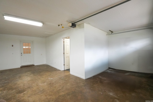 garage with a garage door opener and baseboards