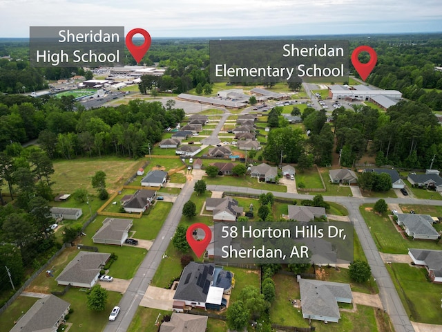 aerial view of property and surrounding area featuring nearby suburban area