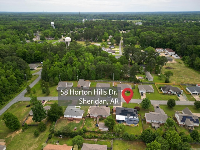 aerial perspective of suburban area featuring a heavily wooded area
