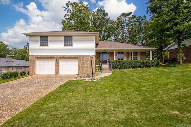 tri-level home featuring brick siding, a front yard, concrete driveway, and a garage