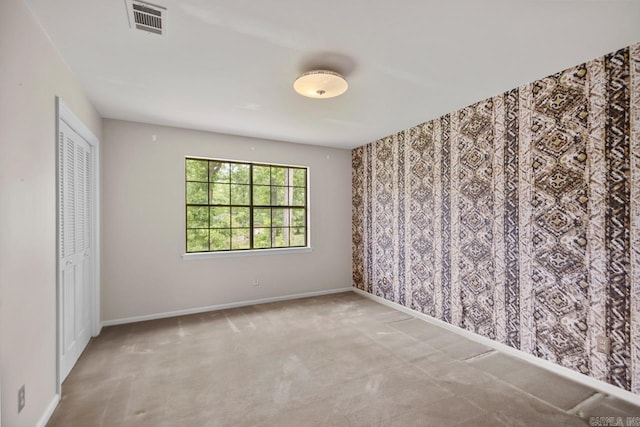 unfurnished bedroom featuring carpet floors, baseboards, and a closet