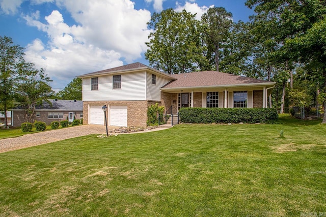split level home featuring brick siding, driveway, an attached garage, and a front yard