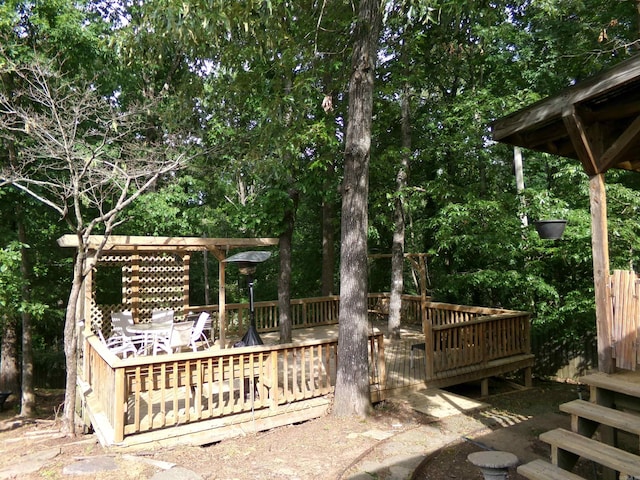 14301 Ridgewood, Little Rock, AR 72211 - view of yard featuring a wooden deck, outdoor dining space, and view of wooded area