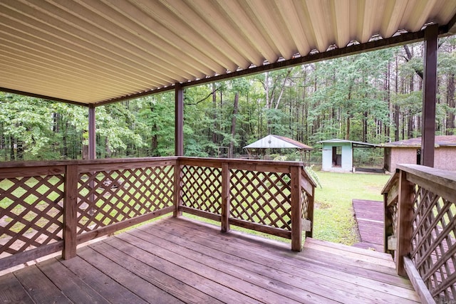 3815 Bruno Rd, Little Rock, AR 72209 - deck with an outbuilding, a wooded view, and a yard