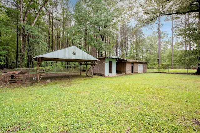 3815 Bruno Rd, Little Rock, AR 72209 - view of yard featuring an outdoor structure, a garage, and a carport
