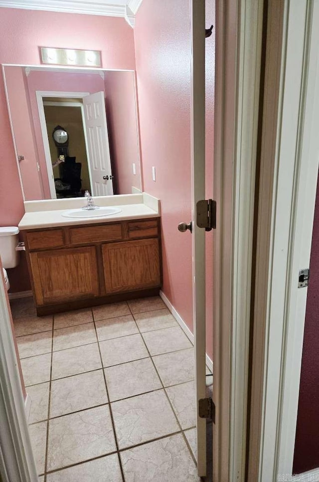 bathroom featuring tile patterned floors, toilet, vanity, and baseboards