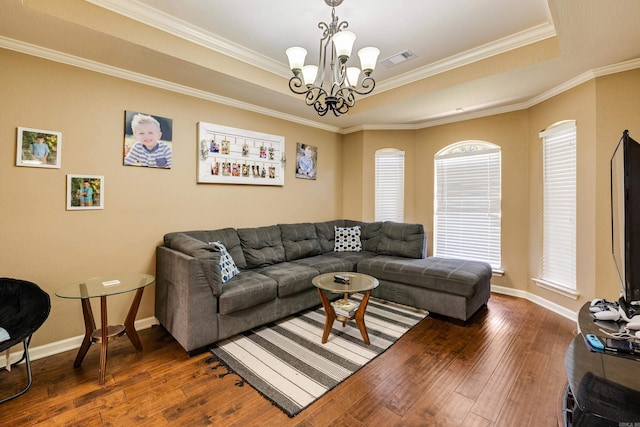 402 Demuth, Benton, AR 72019 - living room featuring a tray ceiling, dark wood-type flooring, ornamental molding, a chandelier, and baseboards
