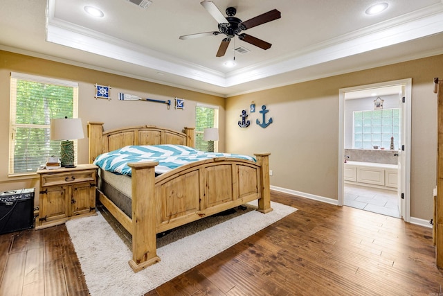 402 Demuth, Benton, AR 72019 - bedroom with ornamental molding, a tray ceiling, dark wood-type flooring, ensuite bath, and baseboards