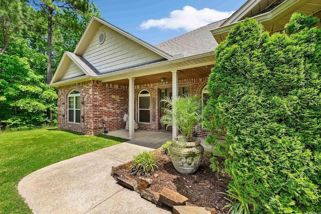 402 Demuth, Benton, AR 72019 - entrance to property with brick siding, roof with shingles, and a yard