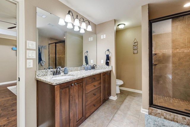 402 Demuth, Benton, AR 72019 - full bathroom with a stall shower, double vanity, toilet, tile patterned floors, and baseboards