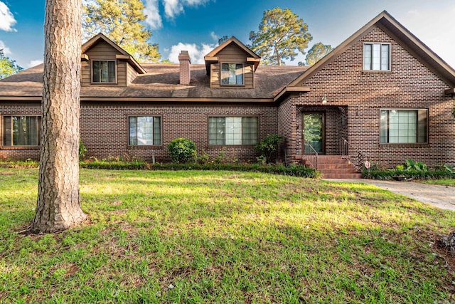 1705 W Cedar St, El Dorado, AR 71730 - view of front of house featuring brick siding, a chimney, a front yard, and roof with shingles