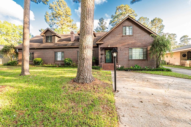 1705 W Cedar St, El Dorado, AR 71730 - view of front of house with brick siding, a front yard, and a chimney