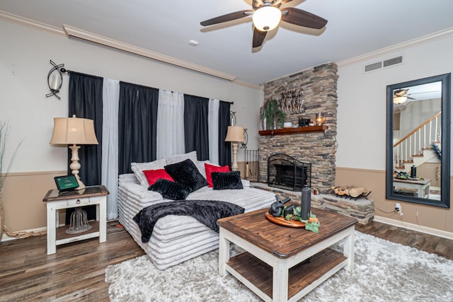 1705 W Cedar St, El Dorado, AR 71730 - living area with a ceiling fan, crown molding, wood finished floors, a stone fireplace, and baseboards