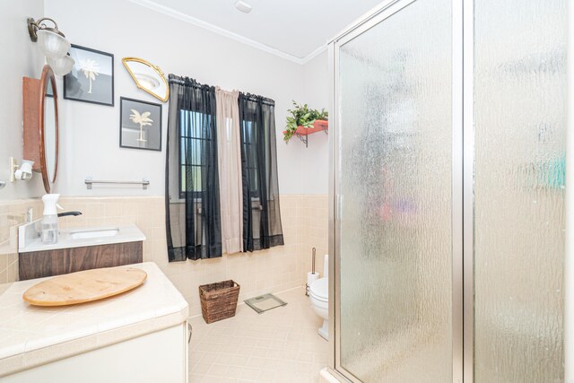 1705 W Cedar St, El Dorado, AR 71730 - bathroom featuring tile walls, crown molding, a stall shower, tile patterned flooring, and toilet