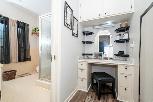 1705 W Cedar St, El Dorado, AR 71730 - bathroom featuring a stall shower, vanity, toilet, and wood finished floors