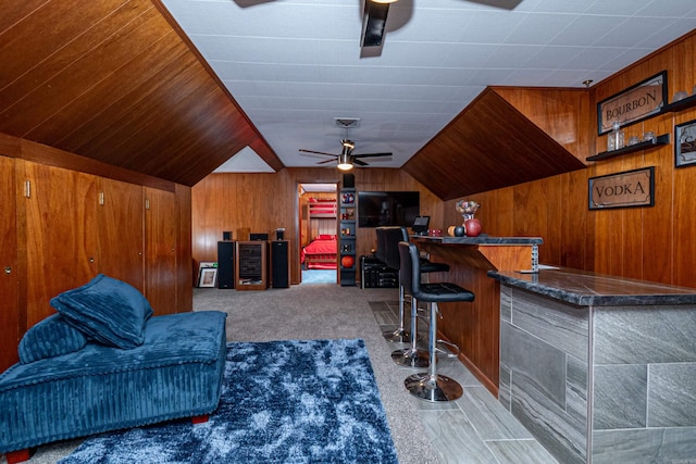 1705 W Cedar St, El Dorado, AR 71730 - indoor dry bar featuring a ceiling fan, wood walls, vaulted ceiling, and carpet floors