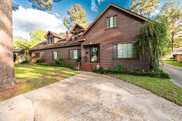 1705 W Cedar St, El Dorado, AR 71730 - view of front of property with brick siding and a front yard