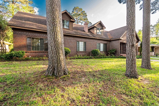 1705 W Cedar St, El Dorado, AR 71730 - view of front of property featuring brick siding, a front lawn, a chimney, and a shingled roof