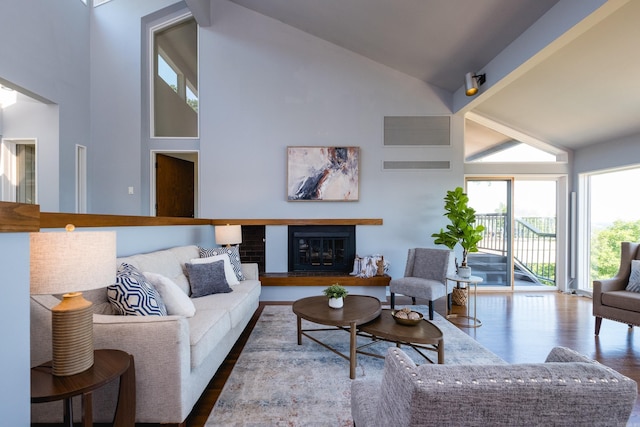 1 Rivers Edge Dr, Little Rock, AR 72227 - living area featuring high vaulted ceiling, wood finished floors, and a glass covered fireplace
