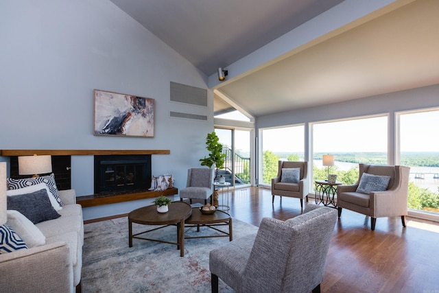 1 Rivers Edge Dr, Little Rock, AR 72227 - living area featuring high vaulted ceiling, wood finished floors, and a glass covered fireplace