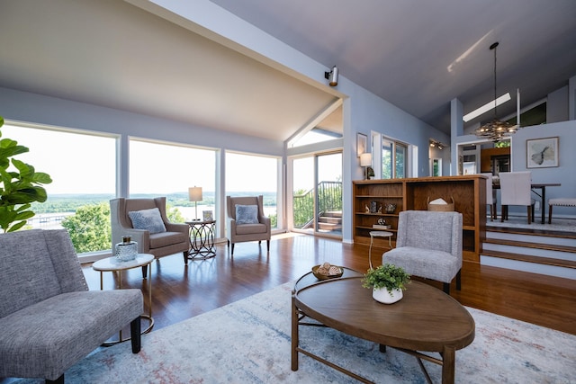 1 Rivers Edge Dr, Little Rock, AR 72227 - living area featuring wood finished floors, plenty of natural light, a chandelier, and high vaulted ceiling