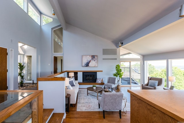 1 Rivers Edge Dr, Little Rock, AR 72227 - living area featuring beam ceiling, a glass covered fireplace, high vaulted ceiling, and wood finished floors