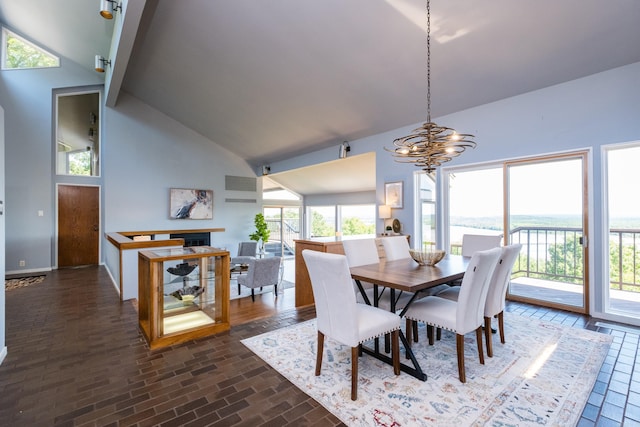 1 Rivers Edge Dr, Little Rock, AR 72227 - dining space with high vaulted ceiling, a chandelier, brick patterned floors, and a fireplace