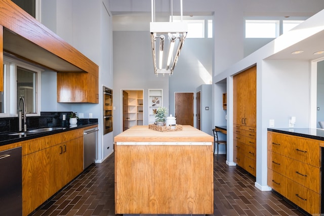 1 Rivers Edge Dr, Little Rock, AR 72227 - kitchen with a high ceiling, a sink, a center island, stainless steel dishwasher, and butcher block countertops