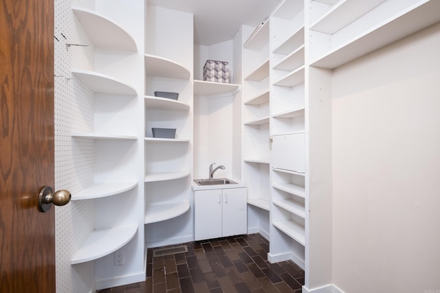 1 Rivers Edge Dr, Little Rock, AR 72227 - walk in closet featuring a sink and dark wood finished floors