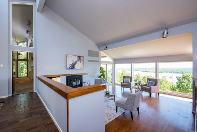 1 Rivers Edge Dr, Little Rock, AR 72227 - living area with a glass covered fireplace, baseboards, high vaulted ceiling, and dark wood-style flooring