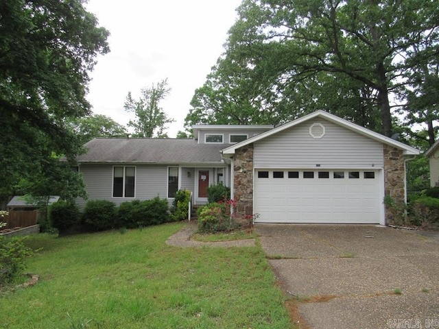 view of front facade with driveway, an attached garage, stone siding, and a front yard