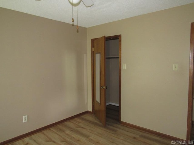 unfurnished bedroom featuring light wood-style flooring and baseboards