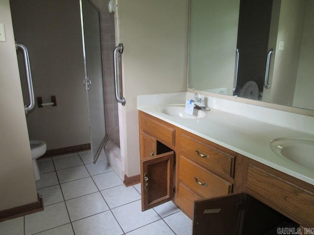 bathroom featuring tile patterned flooring, a shower stall, double vanity, toilet, and baseboards