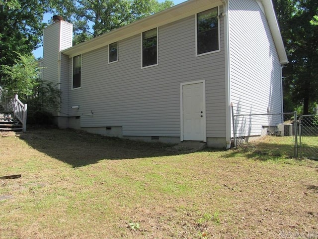 810 Autumnbrook Cir, Sherwood, AR 72120 - back of house featuring crawl space, a chimney, a gate, and central AC
