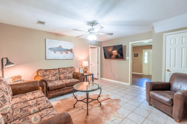 204 Riverside Dr, Pangburn, AR 72121 - living area with light tile patterned floors, ceiling fan, baseboards, and a textured ceiling