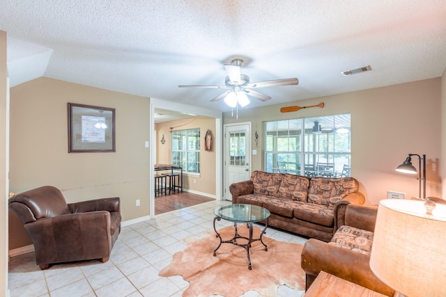204 Riverside Dr, Pangburn, AR 72121 - living room with light tile patterned flooring, a ceiling fan, a textured ceiling, and baseboards