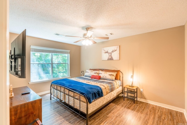 204 Riverside Dr, Pangburn, AR 72121 - bedroom with wood finished floors, baseboards, a textured ceiling, and ceiling fan