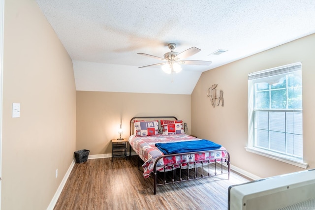204 Riverside Dr, Pangburn, AR 72121 - bedroom with wood finished floors, baseboards, lofted ceiling, a ceiling fan, and a textured ceiling